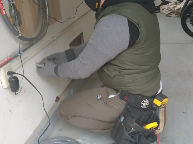 Electrician performing outlet wiring in a Yeadon garage